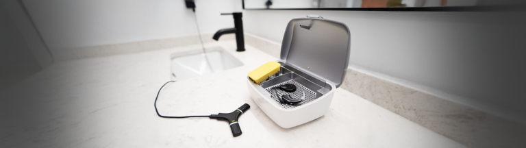 Hearing aid and accessories by the bathroom sink